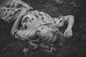 Mt. Lebanon Senior laying in grass in black and white