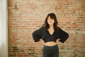 studio brick wall senior girl scrunching nose