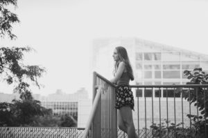 downtown Oakland girl over looking city black and white