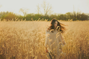 Senior in a field of wheat in the fall