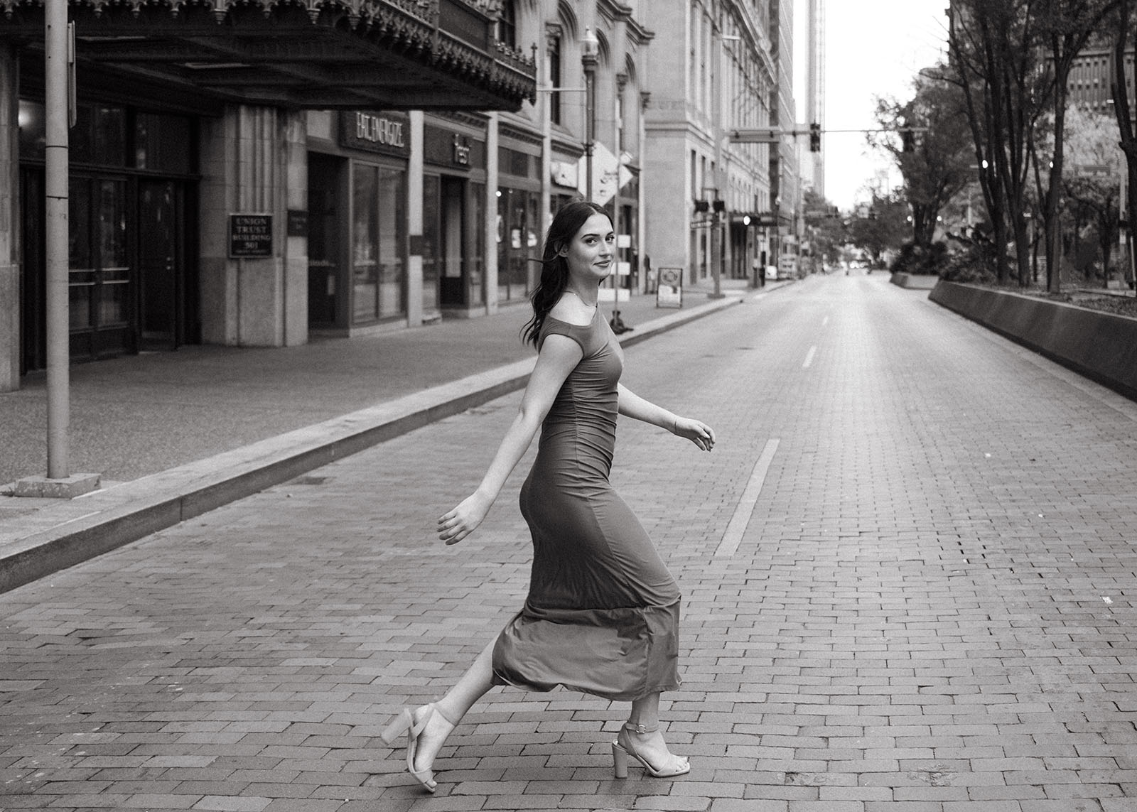 Senior Girl walking across downtown Pittsburgh streets